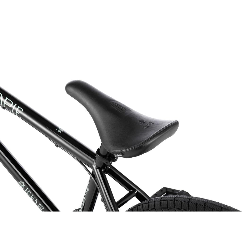 Close-up of a black BMX seat on the Wethepeople Havoc 22 Inch Bike, attached to its black frame with the rear tire and disc brake-ready design visible against a white background.