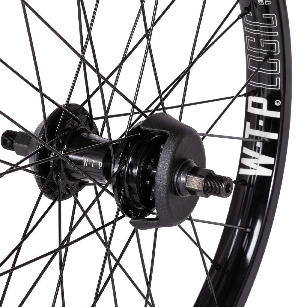 Close-up of a black bicycle wheel with multiple spokes, showcasing the Wethepeople Hybrid Freecoaster Wheel labeled "WTP" and the Wethepeople Logic Rim.