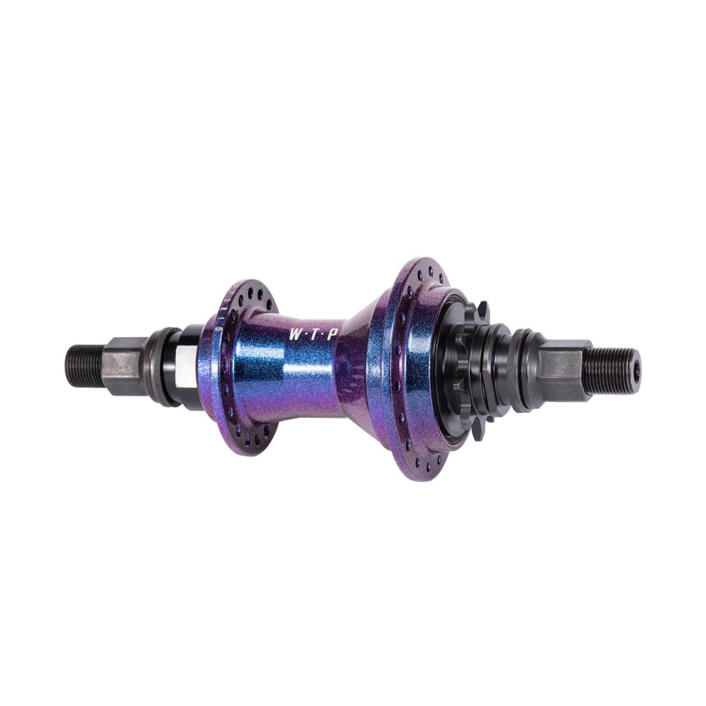 The Wethepeople Hybrid Hub features a metallic purple finish with "WTP" in white. It includes multiple bolt holes, a patented magnetic pawl retention system, and black threaded axles at both ends for smooth performance.