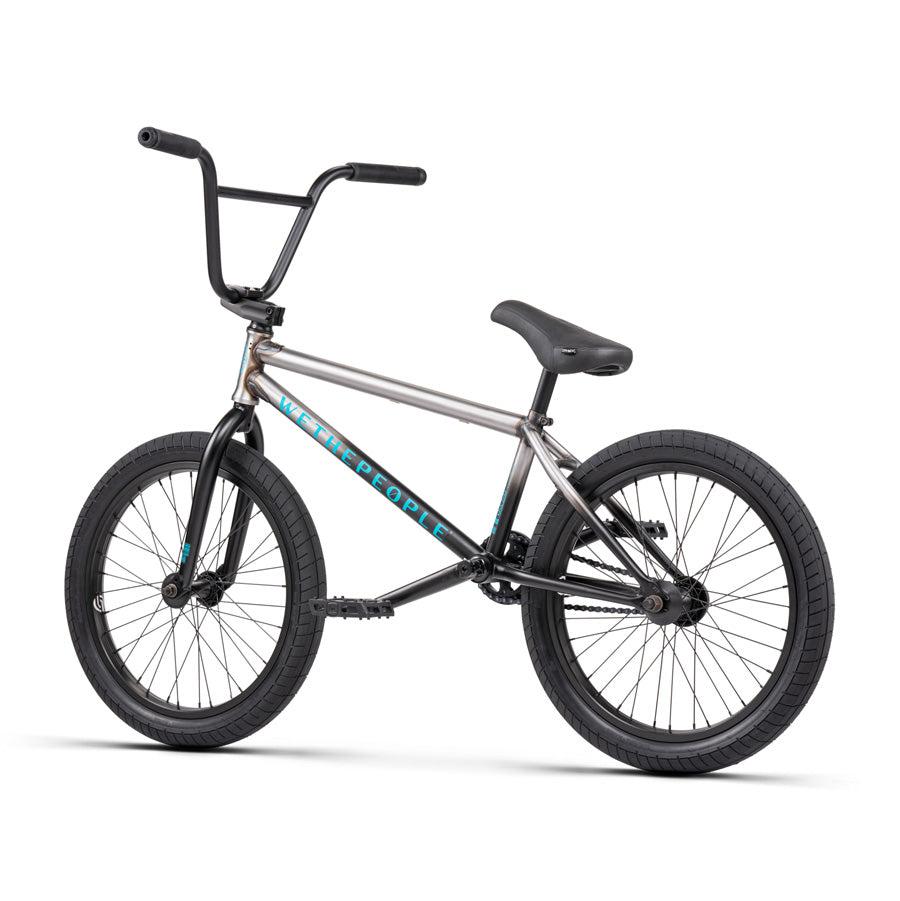 The Wethepeople Justice 20 Inch Bike showcases a stylish grey frame with black handlebars, black tires, and a black seat, all highlighted against a pristine white backdrop. Equipped with premium BMX components, this urban BMX bike is crafted for both aesthetics and high performance.