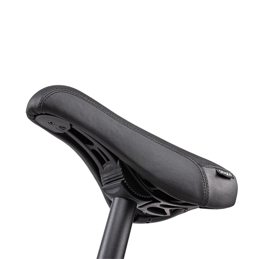 Close-up of a black bicycle saddle with a textured surface and ergonomic design, mounted on a seat post, featuring top-of-the-line BMX components from the Wethepeople Justice 20 Inch Bike.