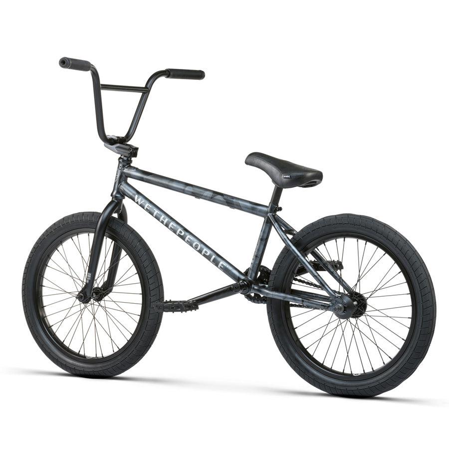 The Wethepeople Justice 20 Inch Bike features a black frame, handlebars, seat, and tires. Subtly adorned with a camo pattern and the "Wethepeople" brand name in white, this urban BMX bike boasts top-of-the-line components for an unbeatable riding experience.