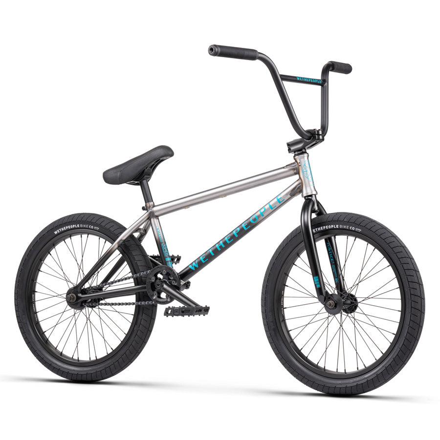 A Wethepeople Justice 20 Inch Bike in silver, featuring black tires, black handlebars, and a padded black seat, is shown against a white background.