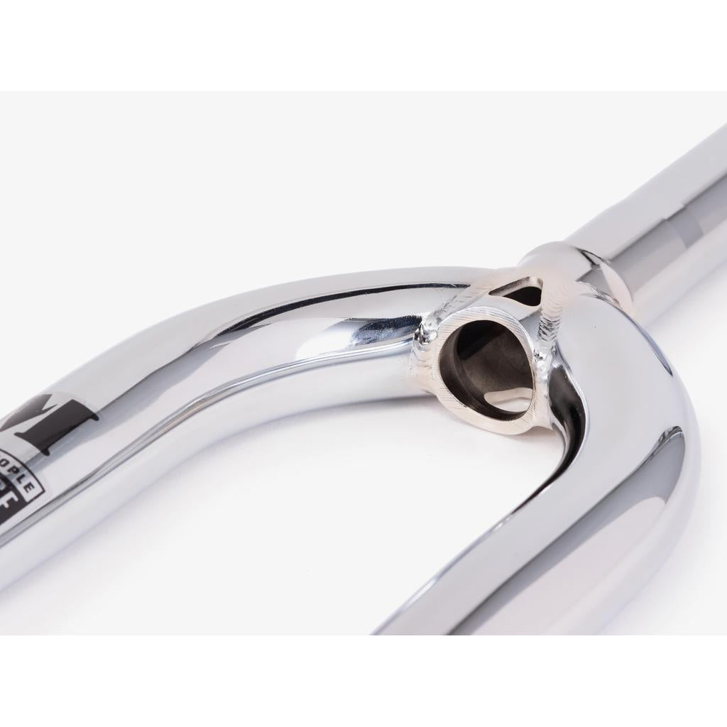 Close-up of the Wethepeople Message Fork, featuring a shiny chrome finish and visible steerer tube hole, showcasing its polished metal surface and clean welds.