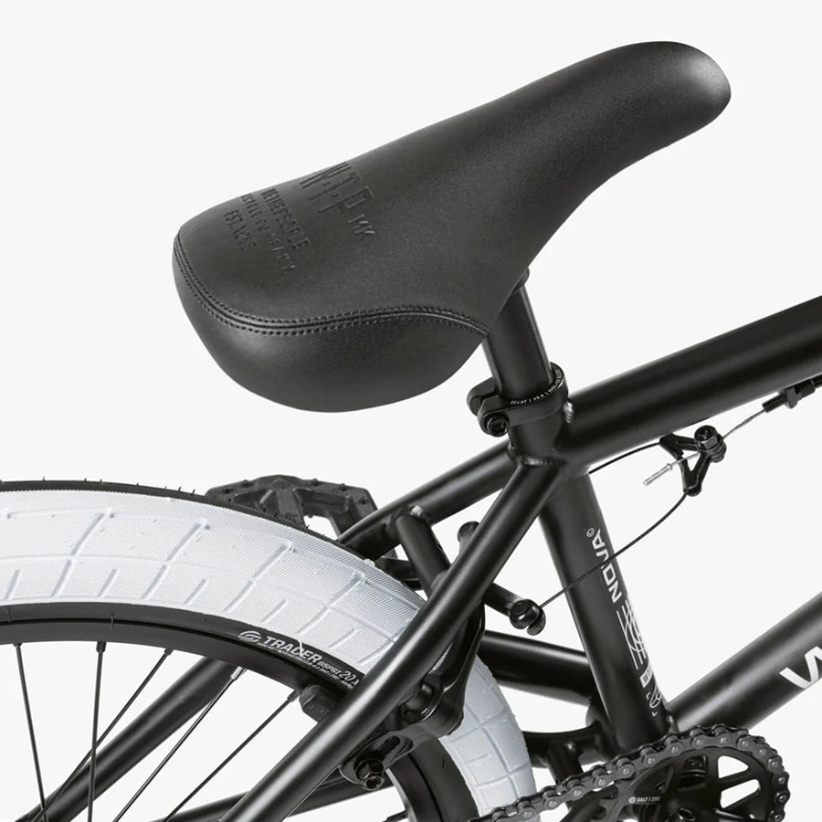 Close-up of the Wethepeople Nova 20 Inch Bike, showcasing the black BMX seat, rear frame, and white rear tire with durable Salt Rookie cranks for an improved riding experience.