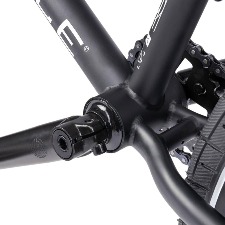 A close up of a Wethepeople Nova 20 Inch BMX bike with a chain on it.