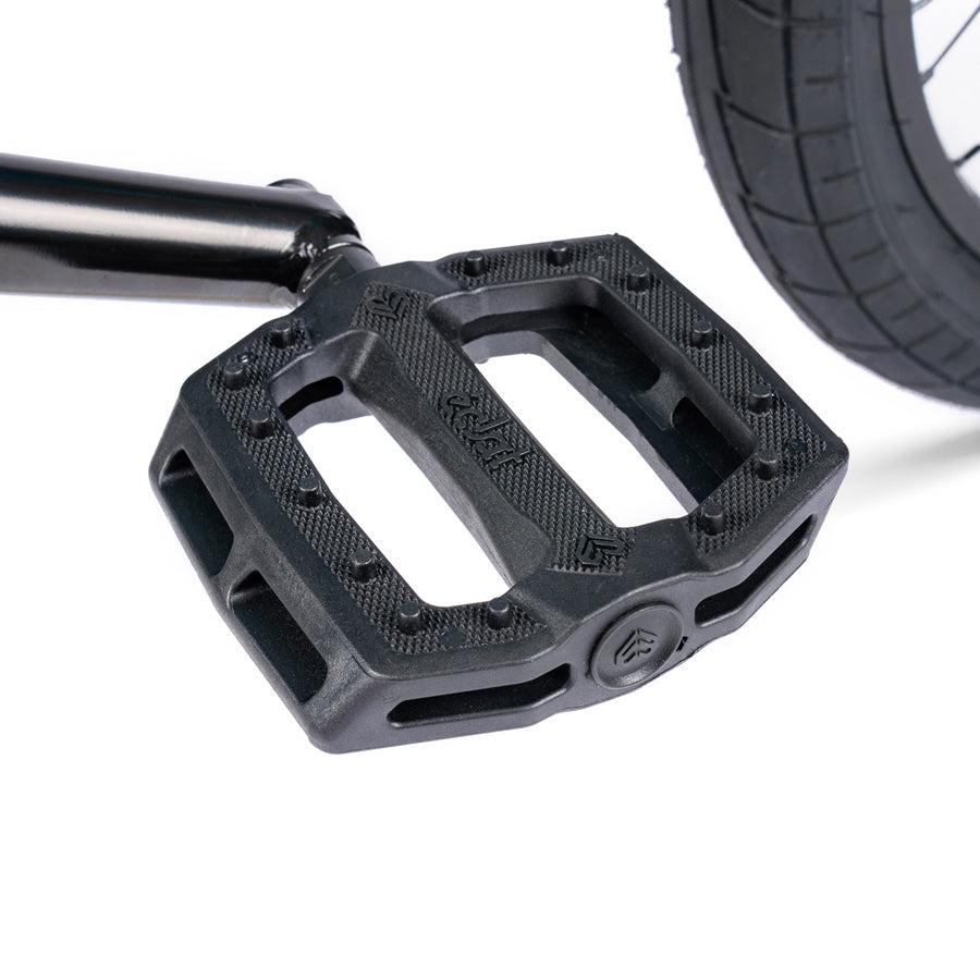 A close up of a black pedal on a Wethepeople Nova 20 Inch BMX Bike.