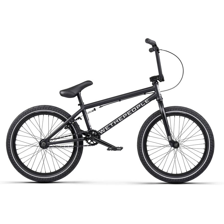 The Wethepeople Nova 20 Inch Bike features a stylish matte black frame and handlebars, accented by Salt Rookie Cranks, with the brand name tastefully shown on the frame.