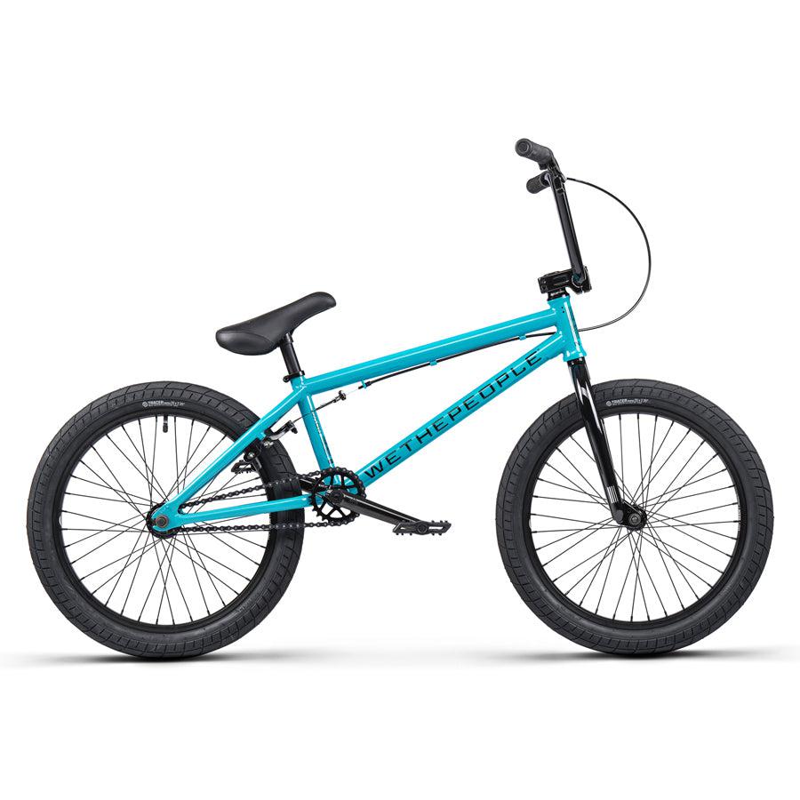The Wethepeople Nova 20 Inch Bike is a turquoise BMX with black tires, branded with a "WETHEPEOPLE" logo on the frame, and includes robust Salt Rookie Cranks for improved riding.