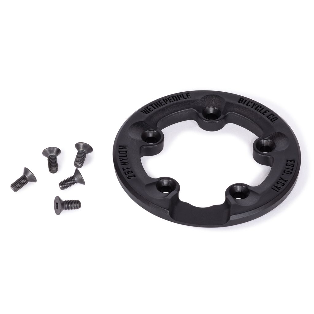 The Wethepeople Paragon Guard Sprocket Guard is a black circular bicycle chain guard with four holes, crafted from durable nylon fiberglass. It is displayed on a white background along with five small black screws and proudly labeled "Wethepeople Bicycle Co.