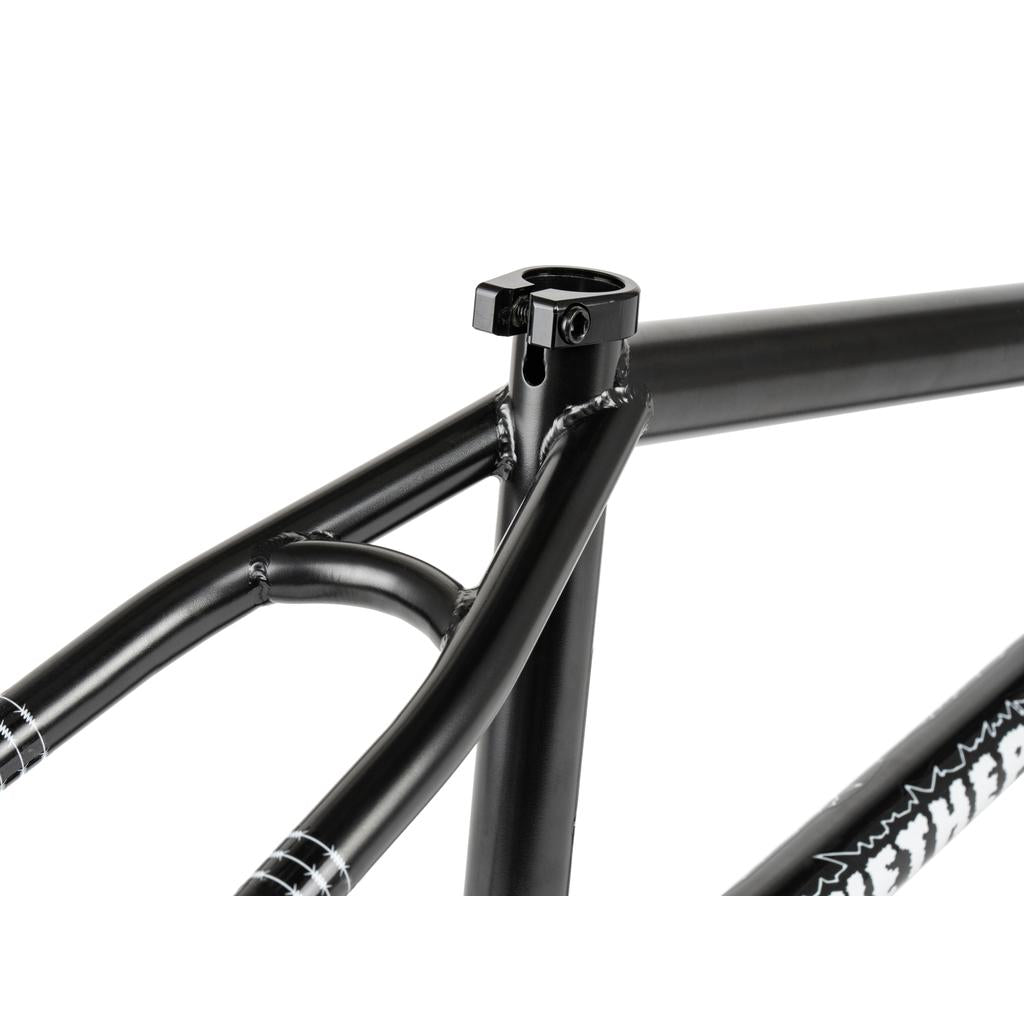 Close-up of the Wethepeople Pathfinder Frame in matte black, highlighting the seat tube junction and seat clamp with part of the logo on the down tube—a signature BMX frame inspired by Felix Prangenberg.