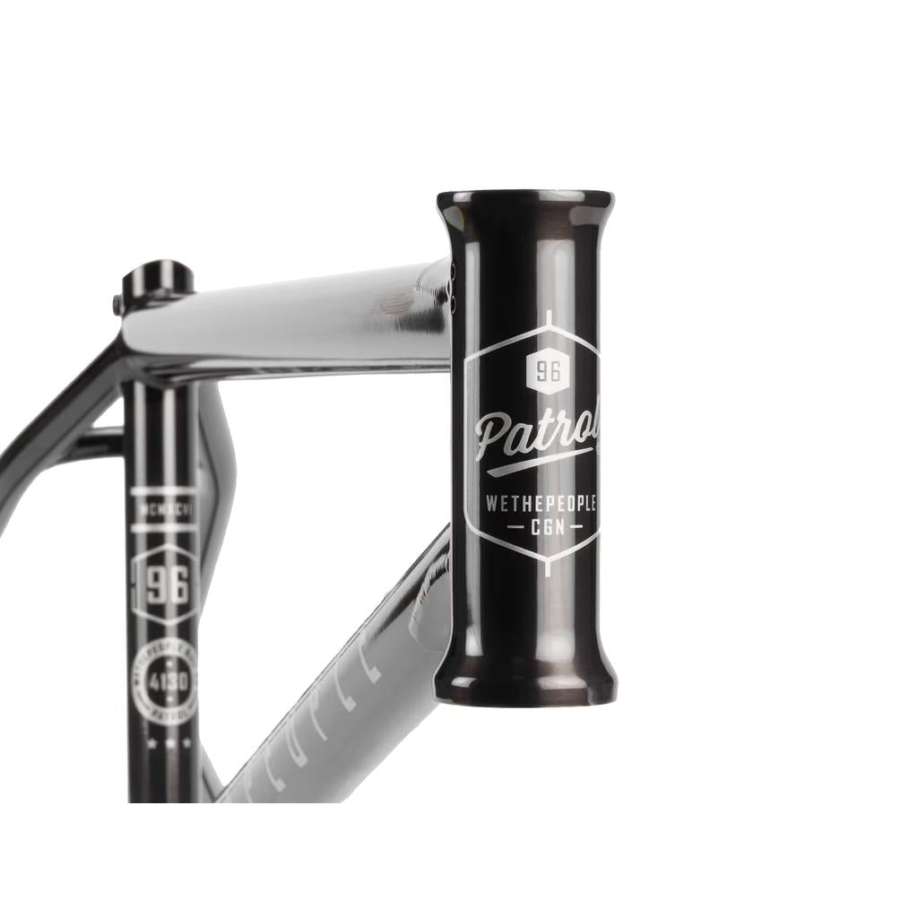 Close-up of the Wethepeople Patrol Frame, crafted from Japanese seamless 4130 chromoly tubing with "Patrol WETHEPEOPLE CO." and "96" in white on the head tube—designed for trails and transition riding.