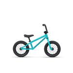 The Wethepeople Prime 12 Inch Balance Bike is a small turquoise model with black tires, handlebars, and seat, displayed on a white background.