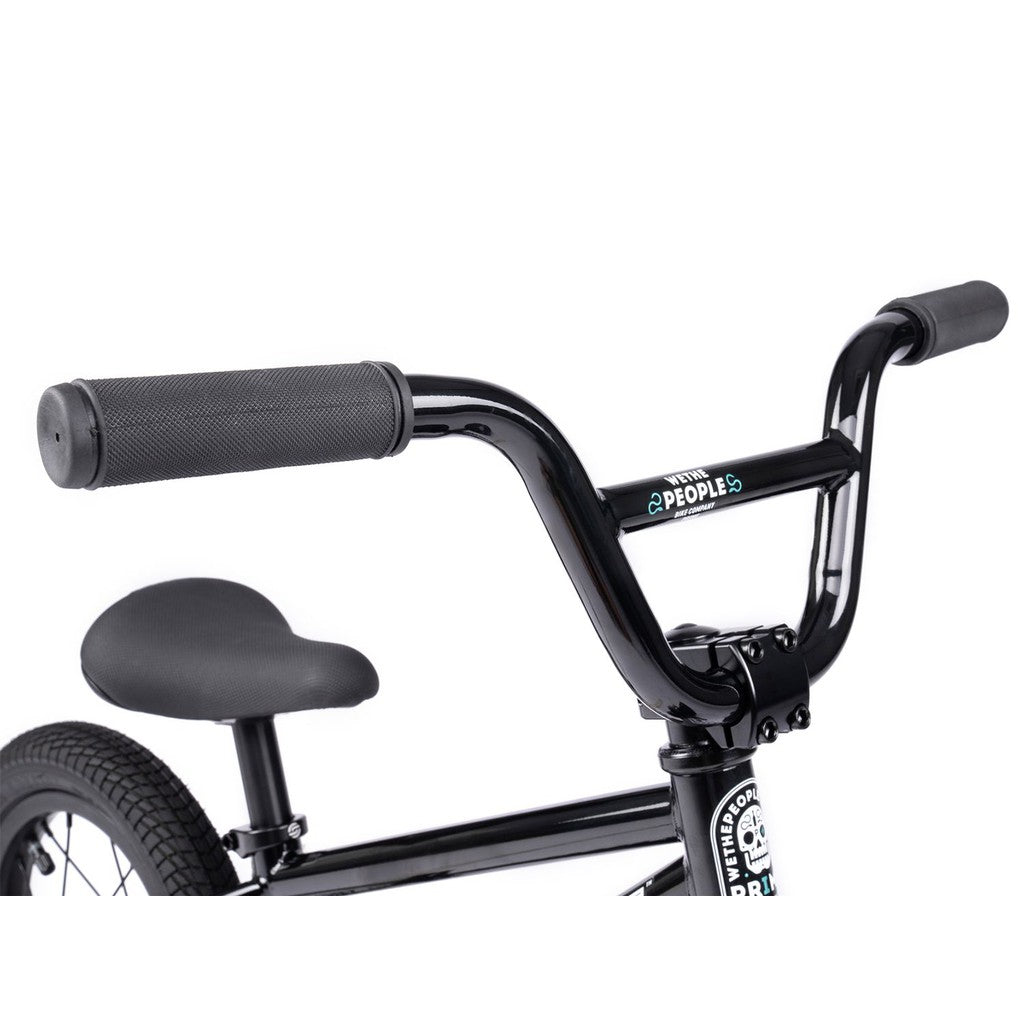 Close-up view of a black handlebar, seat, and frame from the Wethepeople Prime 12 Inch Balance Bike against a white background.
