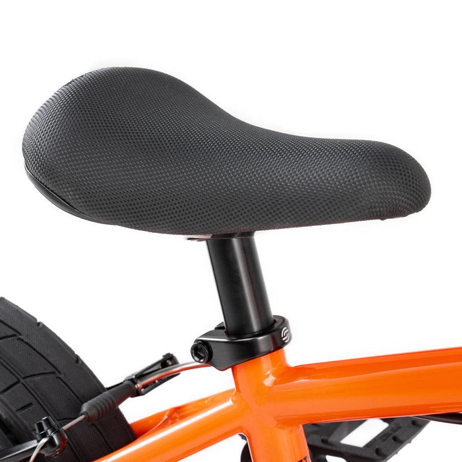 A close up of a Wethepeople Prime Drive 12 Inch Bike with a black seat.