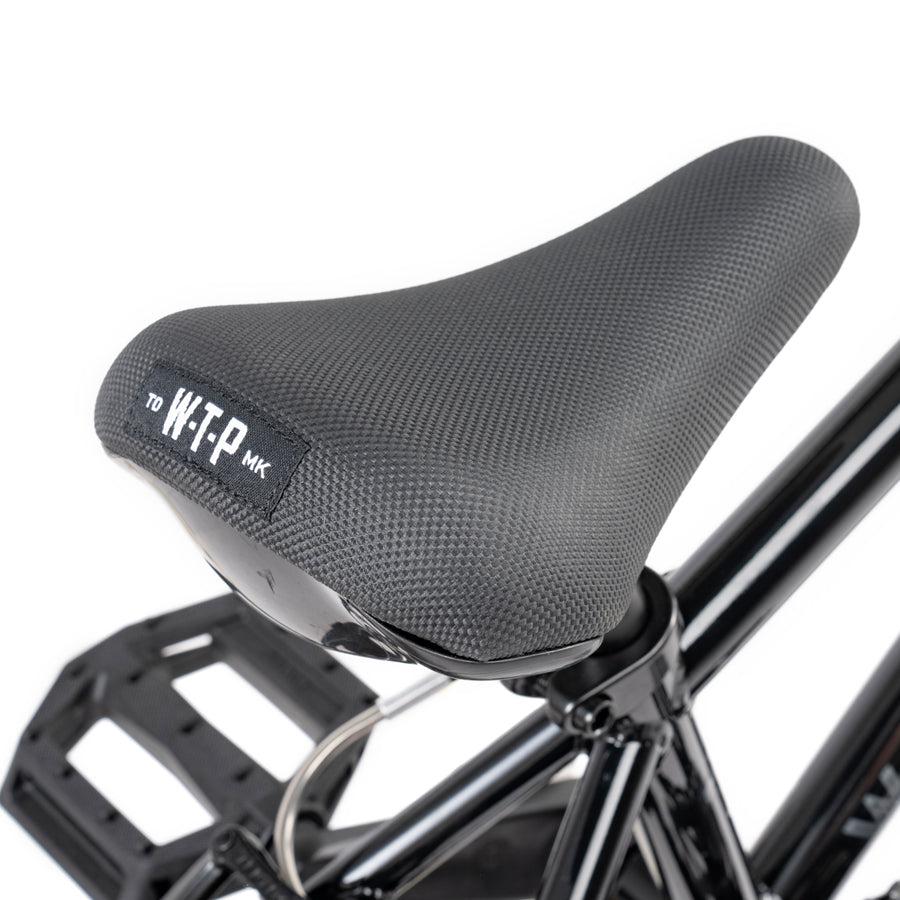 The seat of a Wethepeople Prime Drive 12 Inch Bike with the word "wfp" on it.