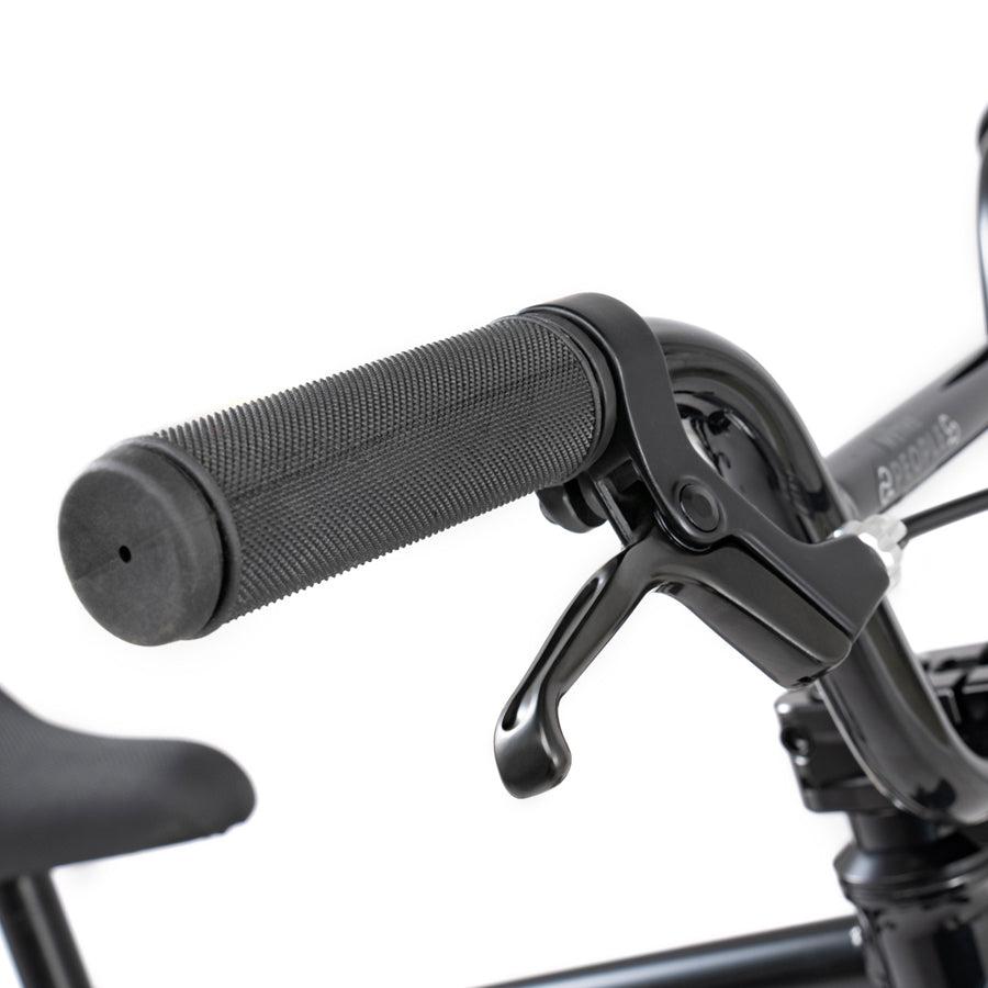 A close up of the handlebar on a black bike with the Wethepeople Prime Drive 12 Inch Bike.
