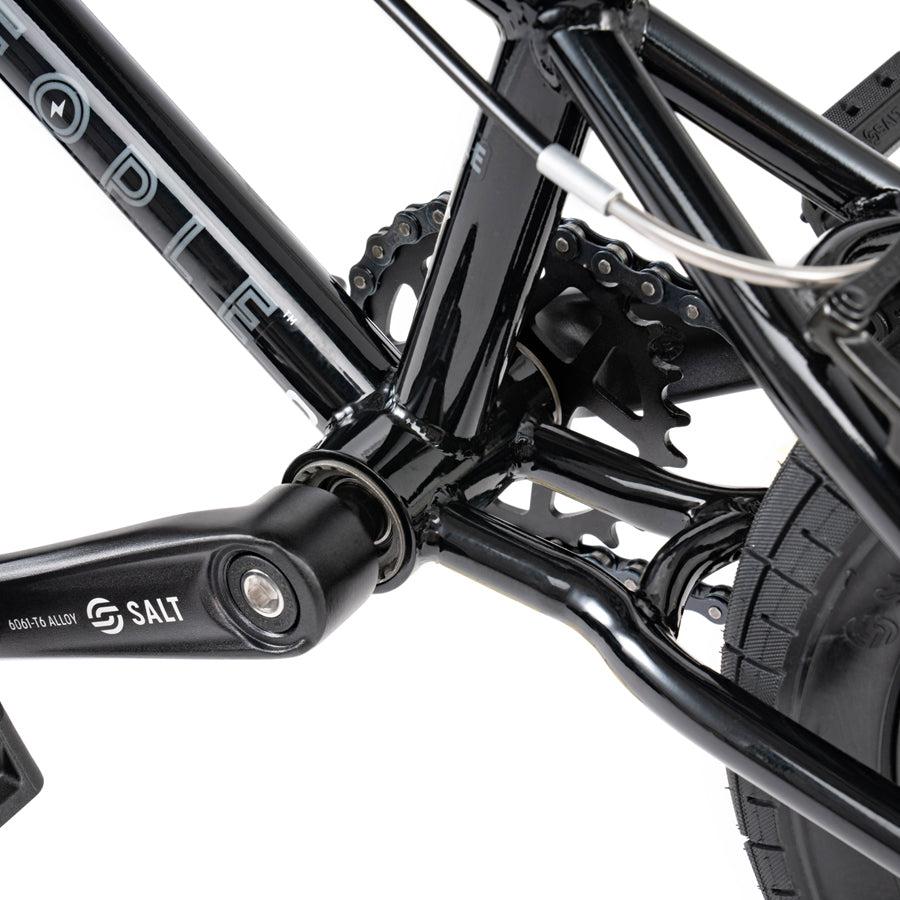 A close up view of a Wethepeople Prime Drive 12 Inch Bike black bicycle.