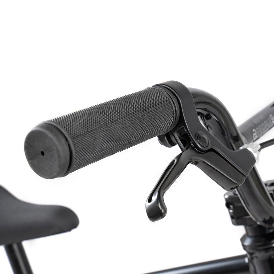 A close up of a black handlebar on a Wethepeople Prime Drive 12 Inch Bike.