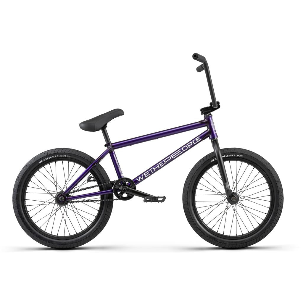The sleek Purple BMX bike boasts a chromoly frame with black handlebars, seat, and wheels. The frame showcases the "Wethepeople" brand and features hybrid equipment.