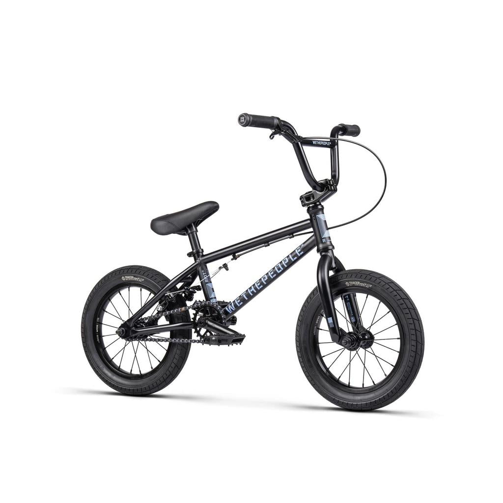 The Wethepeople Riot 14 Inch Bike is a small black BMX-style bicycle featuring thick tires, Chromoly cranks, a padded seat, and straight handlebars, shown against a white background.