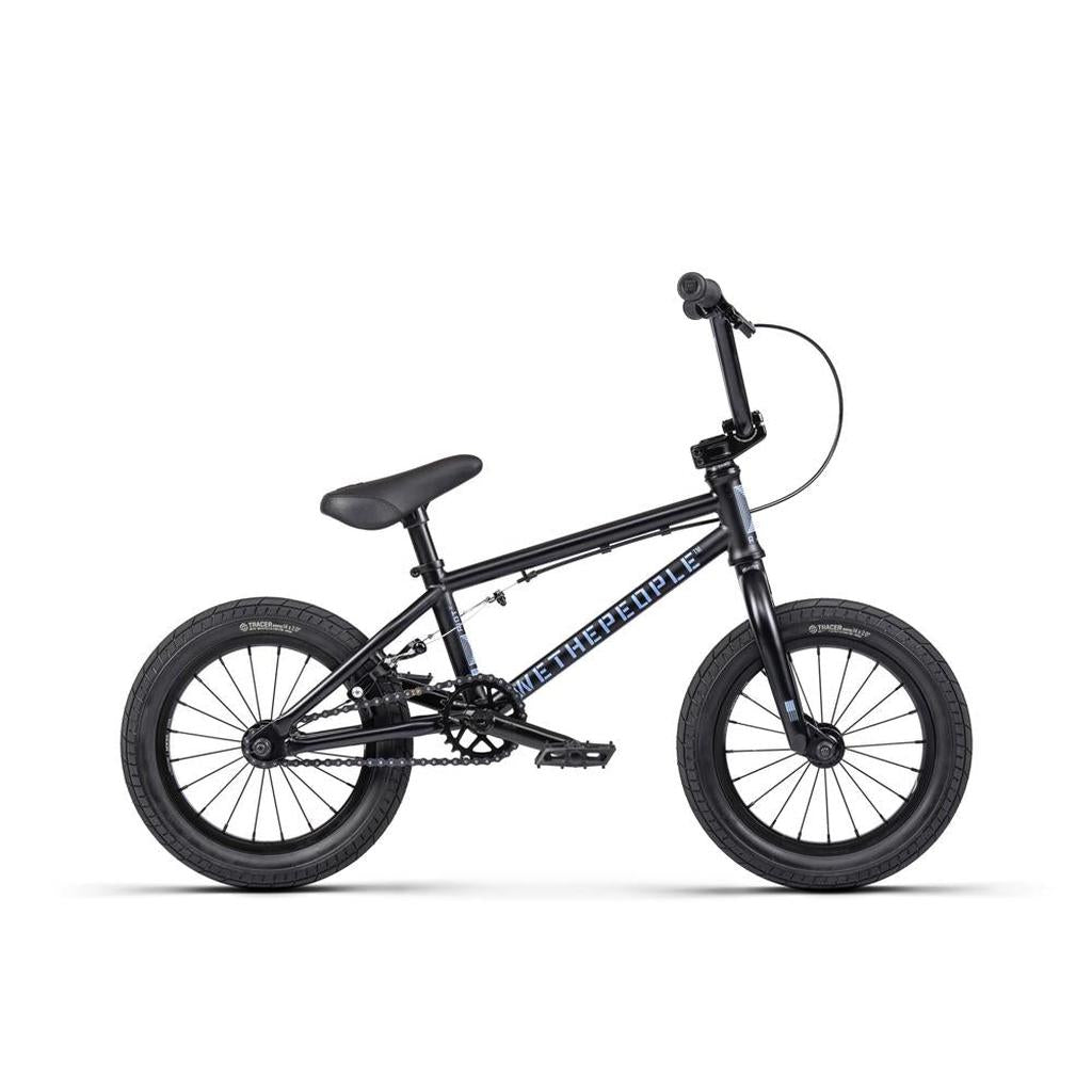 The Wethepeople Riot 14 Inch Bike is a small black BMX with thick tires, chromoly cranks, single gear, front wheel pegs, and "We The People" branding on the frame.