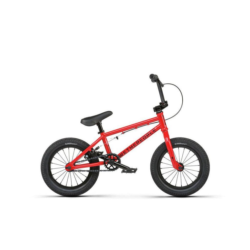 A Wethepeople Riot 14 Inch Bike for children in red, featuring durable Chromoly cranks plus black handlebars, seat, and tires—shown on a white background.
