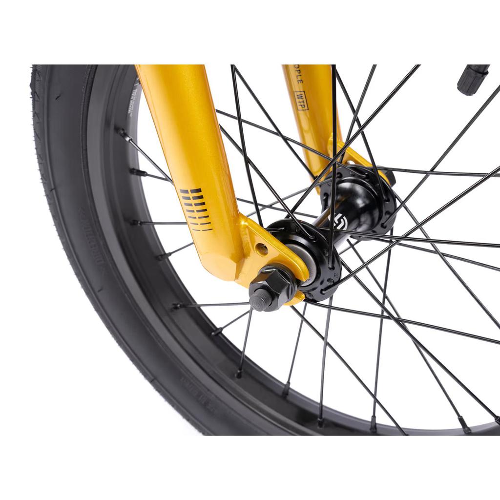 Close-up of a yellow bicycle fork and wheel with black spokes and a "Kenda" tire, showcasing the robust durability of the Wethepeople Seed 16 Inch Bike. Ideal for BMX shredders ready to elevate their biking adventures.