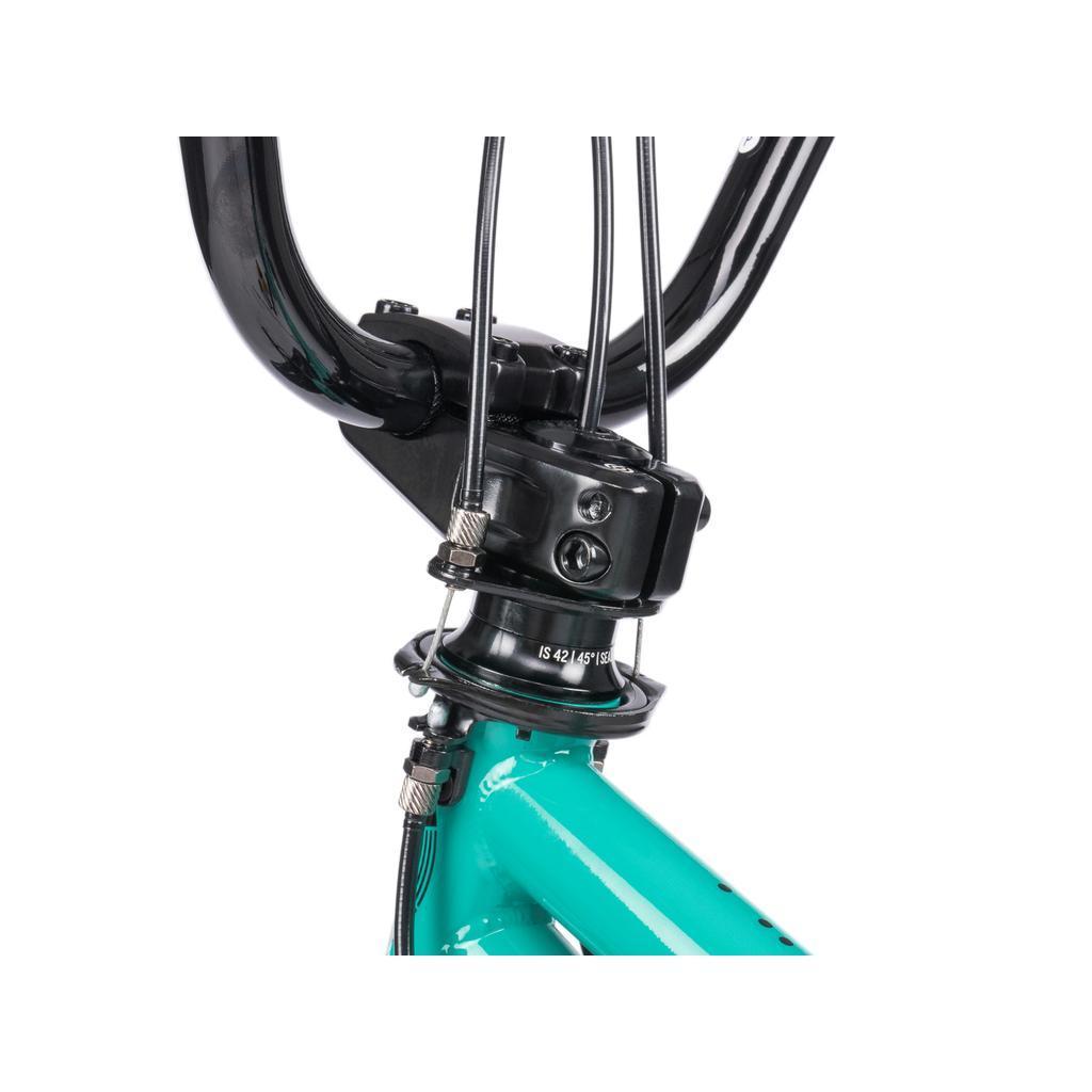 Close-up of the handlebar stem and headset area, showing cables and part of the turquoise Wethepeople Sinus Flatland 20 Inch Bike frame with sleek aftermarket parts.