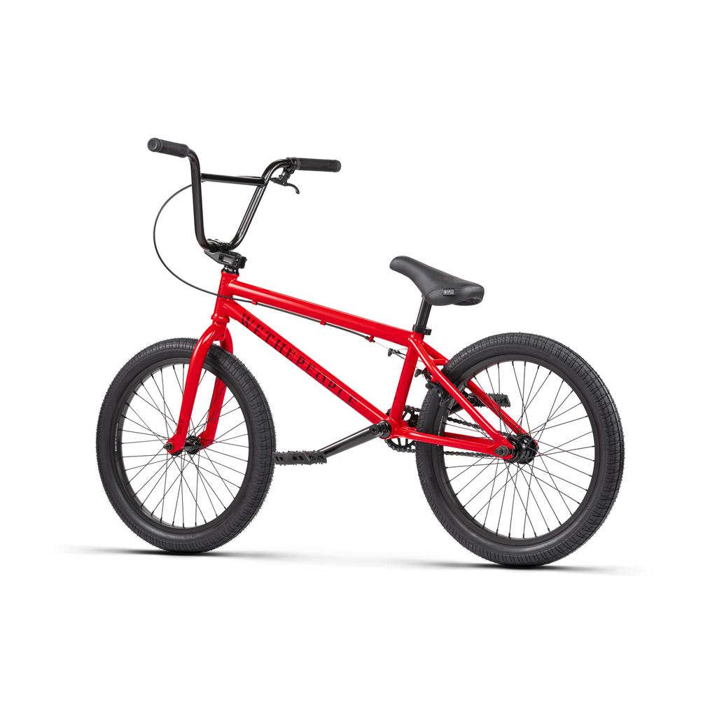 The Wethepeople Thrillseeker 20 Inch Bike is a red freestyle BMX with a durable Hi-Ten frame, black Salt Thrillseeker handlebars, seat, and tires, shown against a white background.