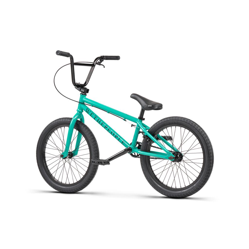 A Wethepeople Thrillseeker 20 Inch bike in teal, featuring black handlebars, seat, and tires, is shown from the side against a white background.