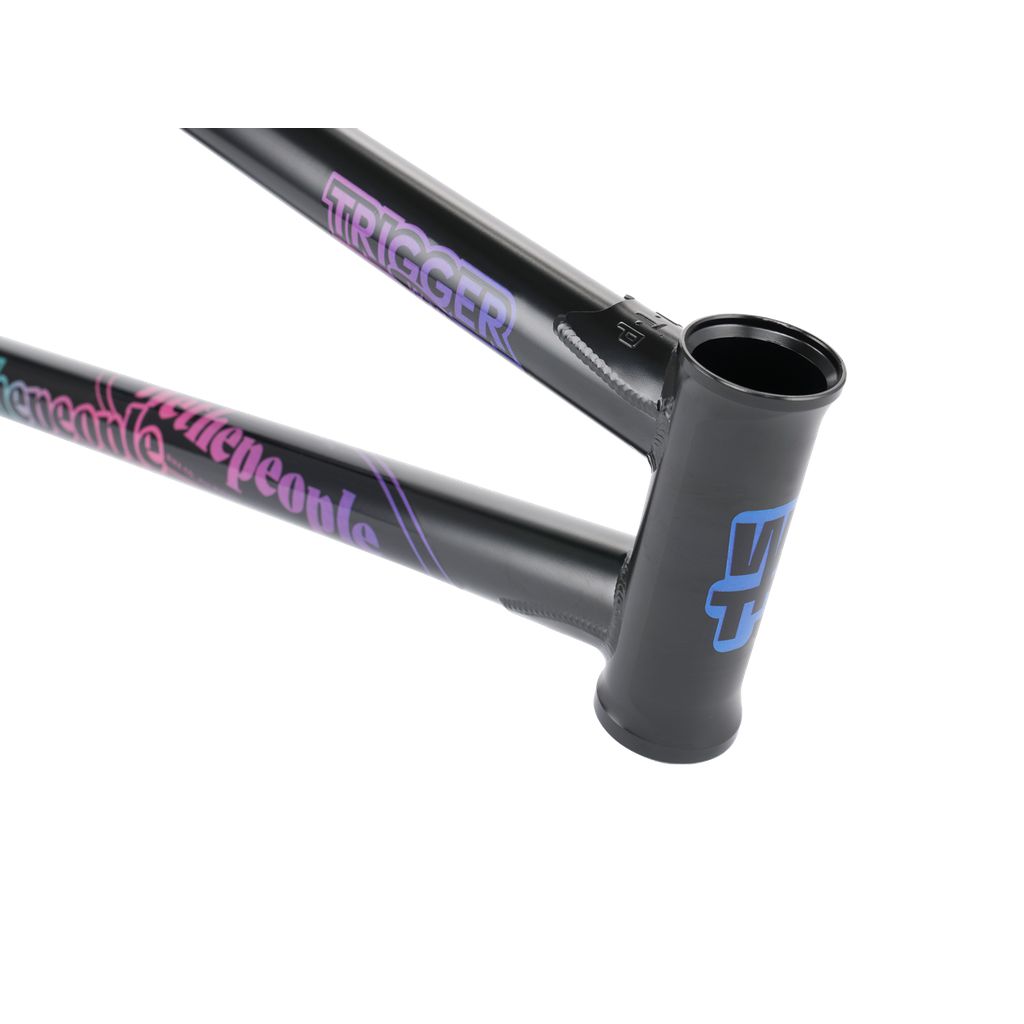 Close-up of the Wethepeople Trigger Frame, a black bicycle frame with vibrant branding that includes "Trigger" and "We the People." It showcases a sturdy frame with adaptive geometry and a large open head tube, proudly representing the WTP AM team.