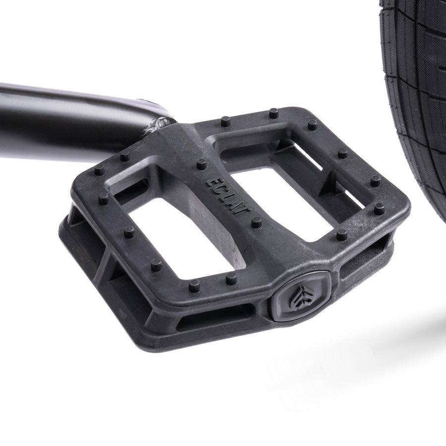 Close-up of a black bicycle pedal attached to a crank arm, featuring a textured surface and the visible logo, seamlessly enhancing the bold design of the Wethepeople Trust 20 Inch Freecoaster/Hybrid Bike.