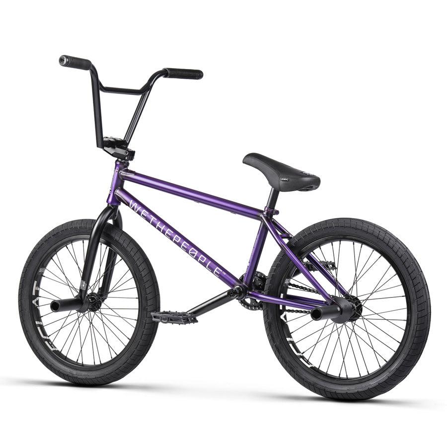 Displayed in a side view against a white background, the Wethepeople Trust 20 Inch Freecoaster/Hybrid Bike showcases its stylish design with a purple frame and black handlebars, tires, and seat. This sleek bike is designed with battleship geometry to ensure both form and function.