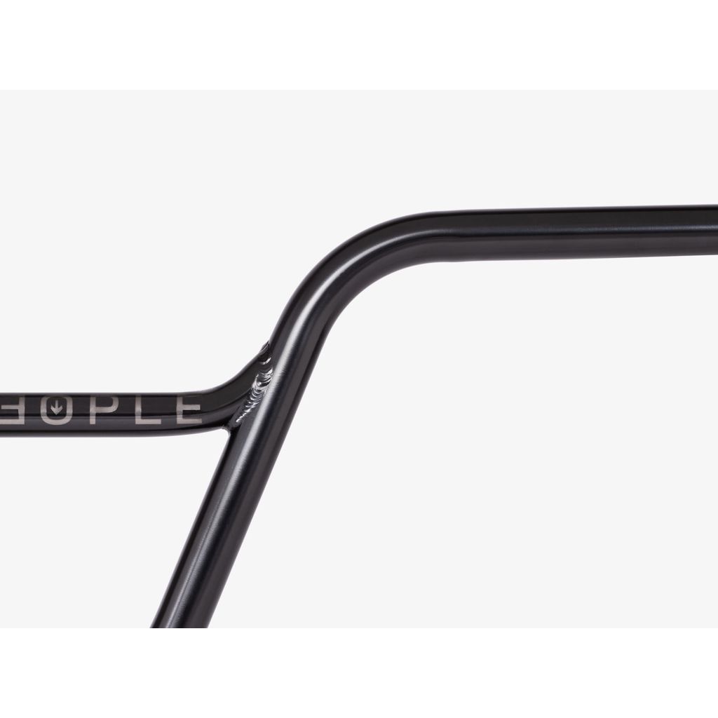 Close-up of a sleek black Wethepeople Utopia Flatland Handlebar, with the word "PEOPLE" partially visible on the left side, adding intrigue.