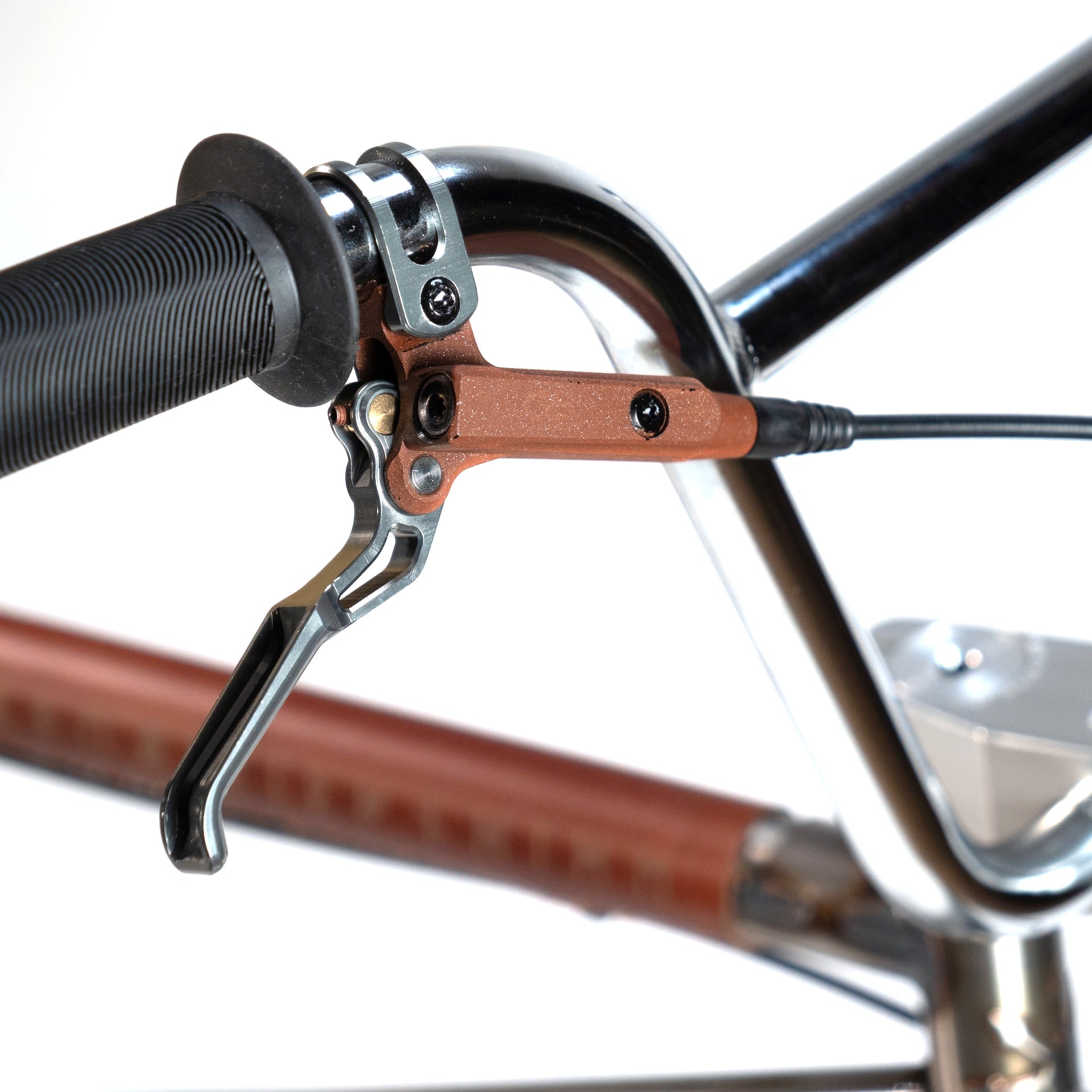 Close-up of a bicycle handlebar featuring an Eclat Controller Bars brake lever and grip. The partly visible frame suggests this might be a Wethepeople X LUX LAB 'Ironhide' Chaos Machine 20 Inch Custom Bike.