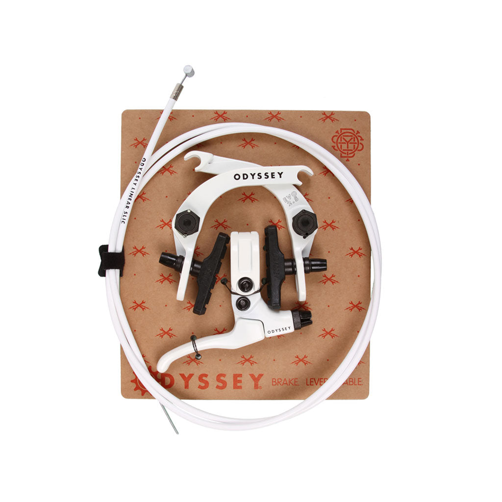 An Odyssey Evo 2.5 Brake Kit, featuring a white lever, assorted black attachment parts, and white cable, compatible with Evo 2.5 brake systems, displayed on a cardboard background with logos and