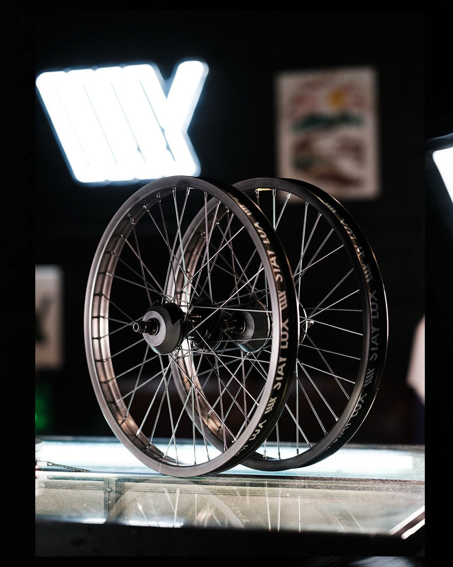 Two Federal Motion x Odyssey Stage 2 rear wheels on the LUXBMX counter under the LUX Symbol sign