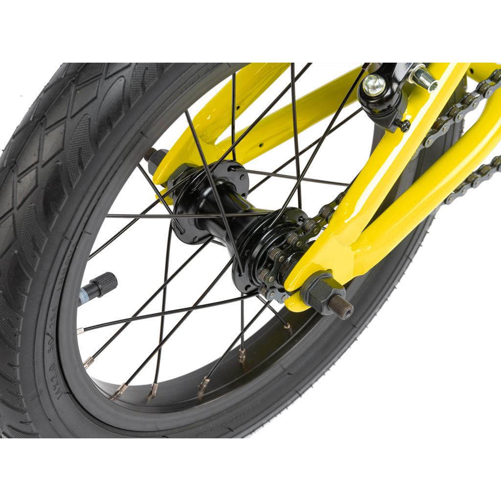 Close-up of the rear wheel and yellow frame of the Radio Revo 14 Inch bike, highlighting the tire, black spokes, axle, and chain against a white background.
