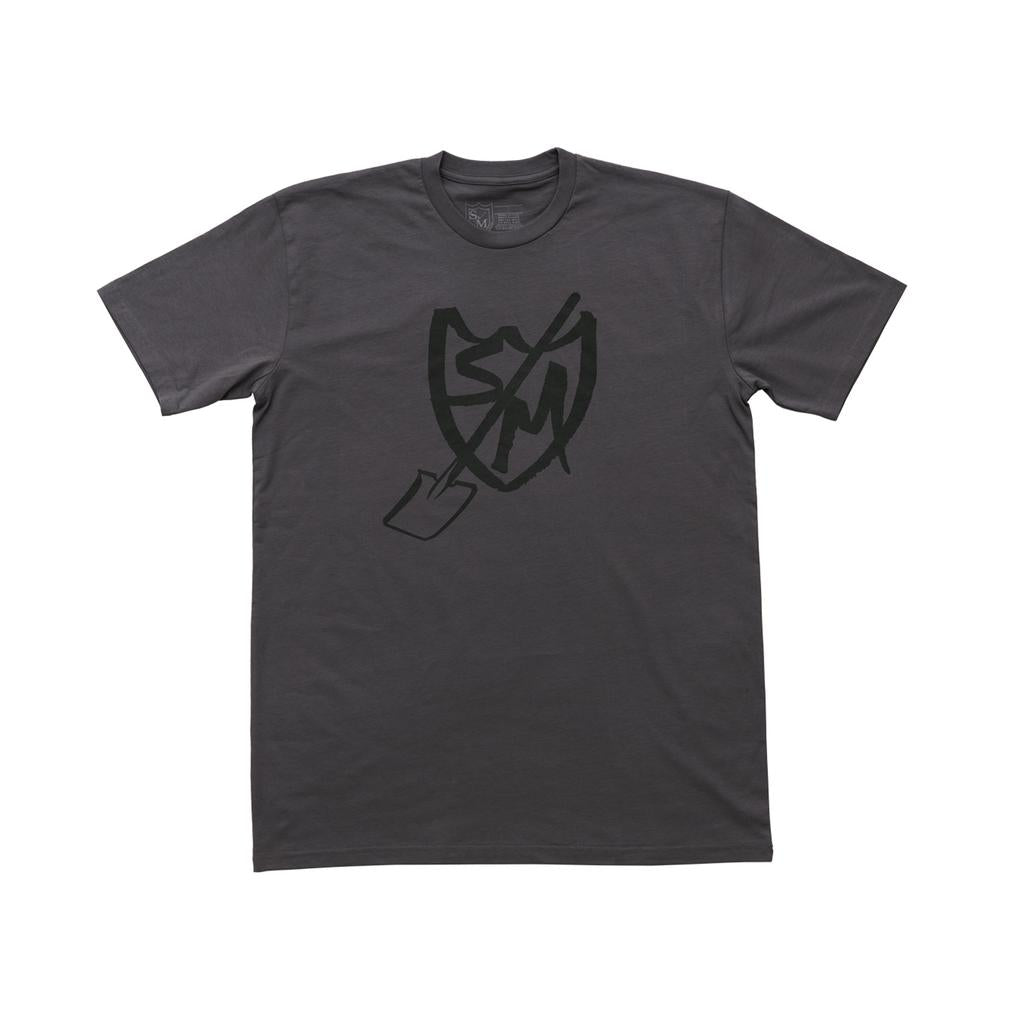 The S&M Shovel Shield T-Shirt is a plain dark gray tee with a black Sharpie Shield graphic—featuring a shield, shovel, and "SM" letters—printed on the front.