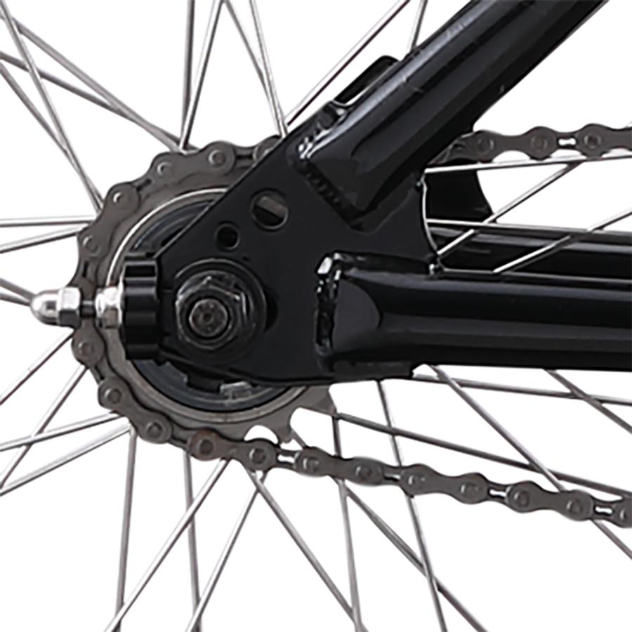 Close-up of the Redline PL 26 Inch Bike’s rear wheel highlights the chain, spokes, and black chromoly steel frame, inspired by the classic BMX cruiser design.