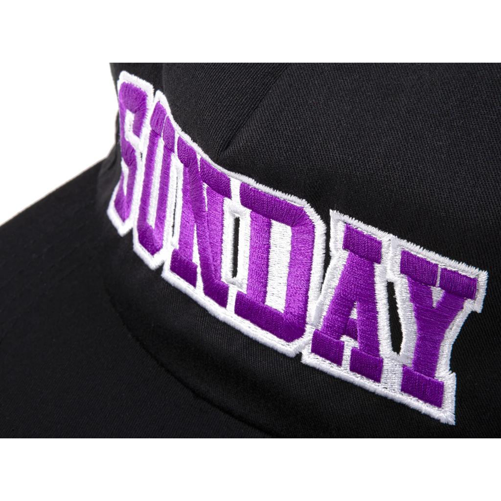 The Sunday Blockhead Cap showcases "SUNDAY" boldly embroidered in purple and white across the front.