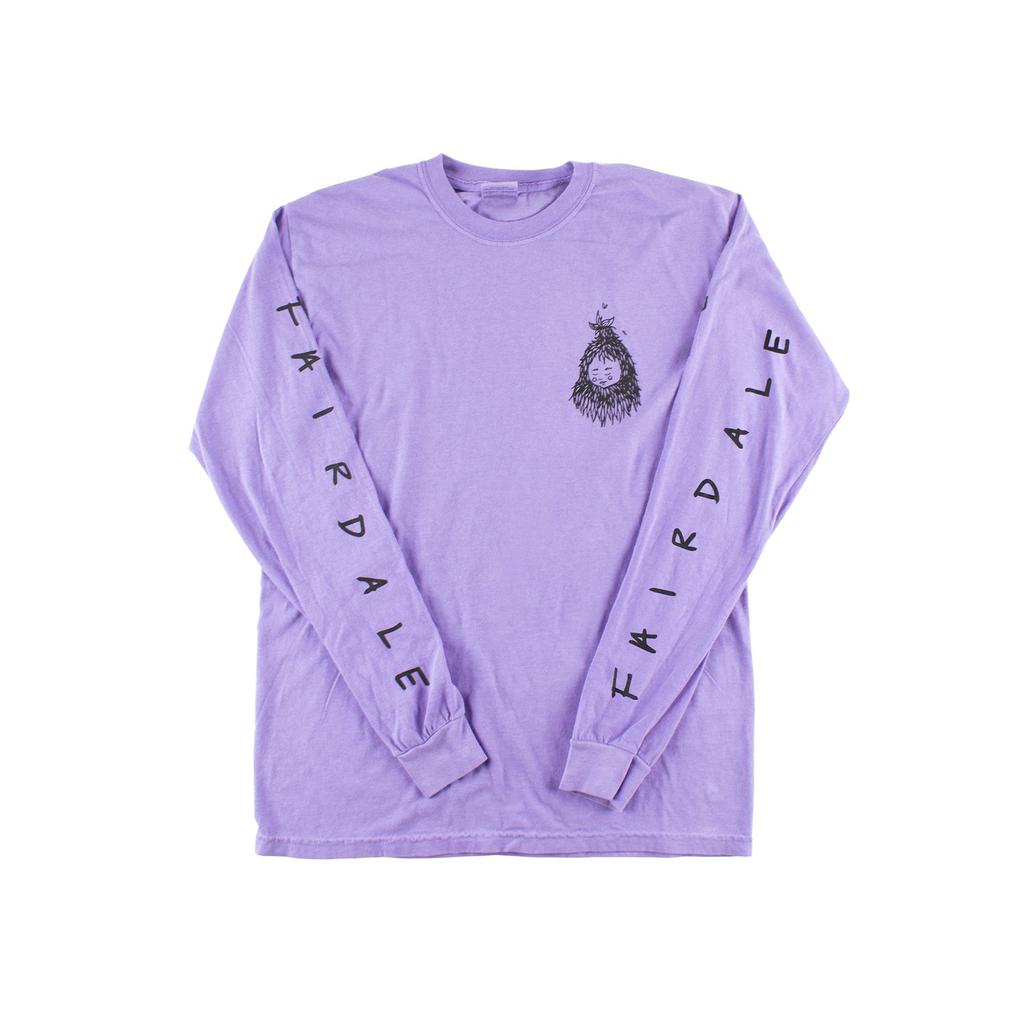 The Fairdale Nora V Long Sleeve T-Shirt is a heavyweight cotton lavender top with "FAIRDLAE" in black on both sleeves and a small black graphic on the left chest.