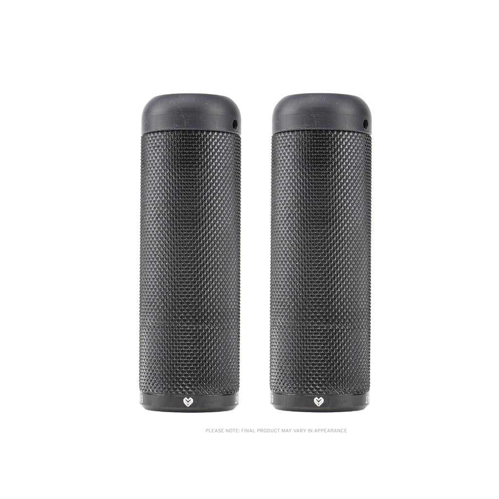Two identical black cylindrical portable speakers, standing upright side by side on a white background, closely resemble a pair of sleek Eclat Emery Axle Pegs.