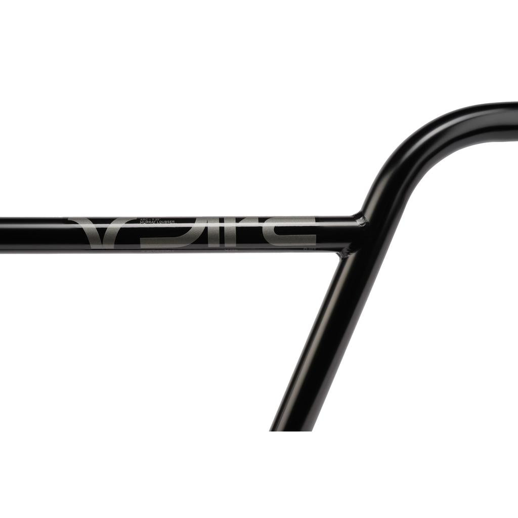 Close-up of the black metal Wethepeople ARC (Murray Loubser) Bars with “ELITE” in silver lettering across the crossbar, featuring a 4130 chromoly construction and inspired by Murray Loubser’s signature BMX street handlebar design.