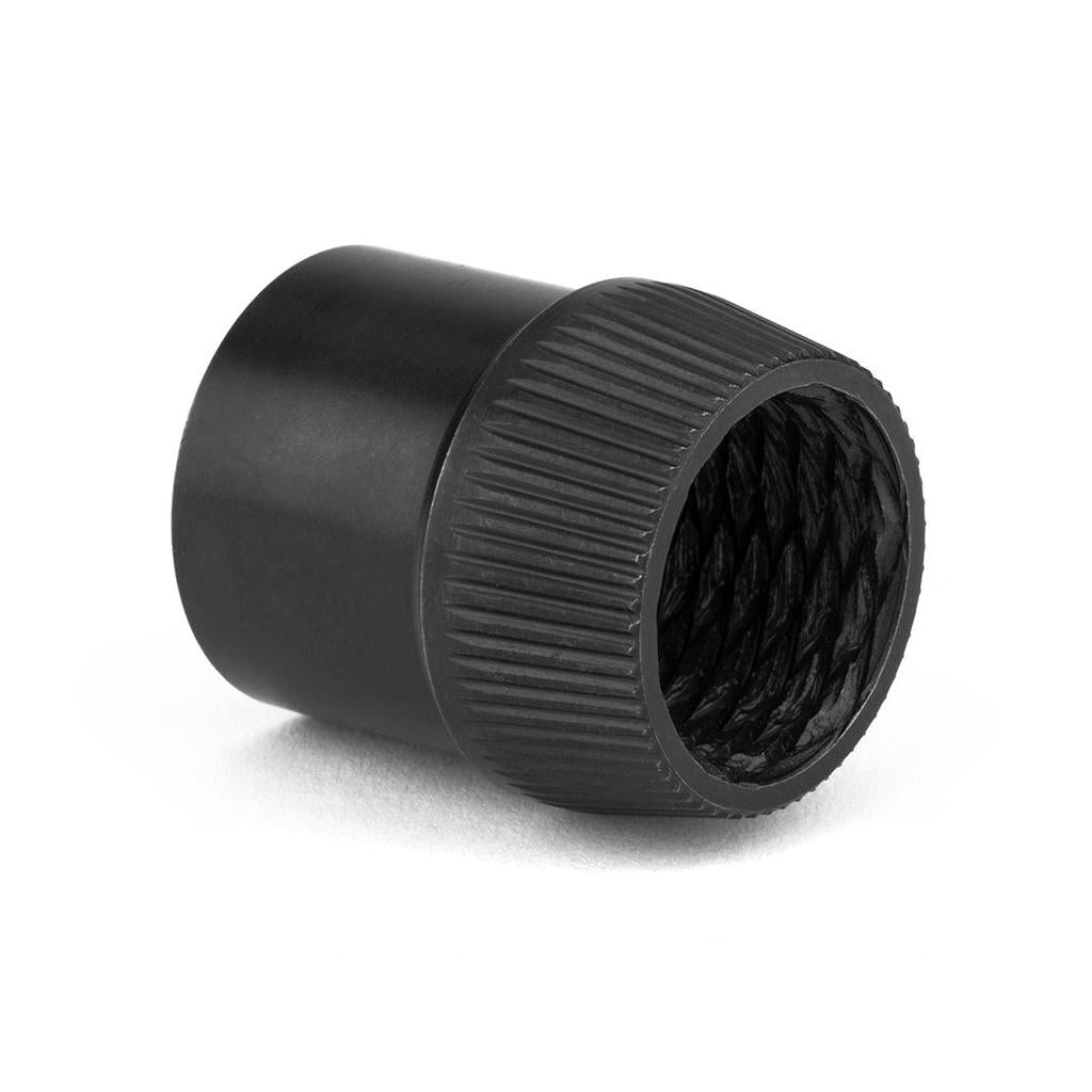 A black, cylindrical knurled metal cap with a threaded interior for the Cinema FX2 Hub Clutch system lies on a white surface.