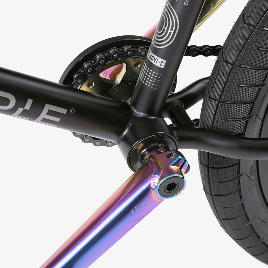 An urban warriors' high-performance ride, showcasing a Wethepeople Reason 20 Inch BMX Bike with a rainbow colored chain.