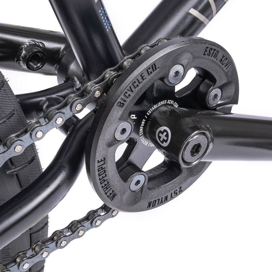 A close up of a chain on a Wethepeople Trust 20 Inch Cassette Bike.