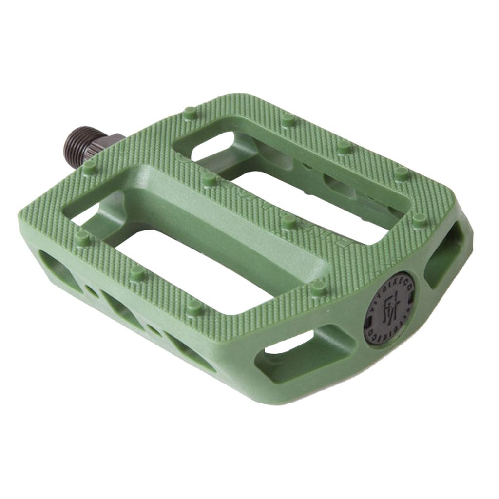 The Fit Mac Plastic Pedals are green, rectangular pedals featuring a nylon body, textured surface, metal axle, concave shape, and open slots for enhanced grip.