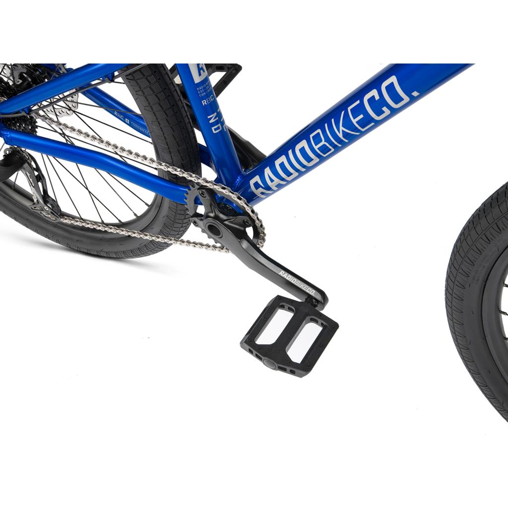 Close-up of the Radio Fiend 26 Inch Bike’s blue 6061-T6 alloy frame, chain, crank, and pedal on a white background. The “RADIOBIKECO.” branding is featured on the durable frame.